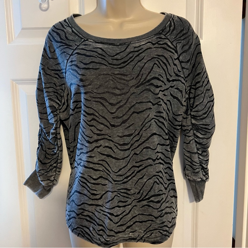 Grey and black animal print, rushed 3/4 length sleeves. Thermal like material.